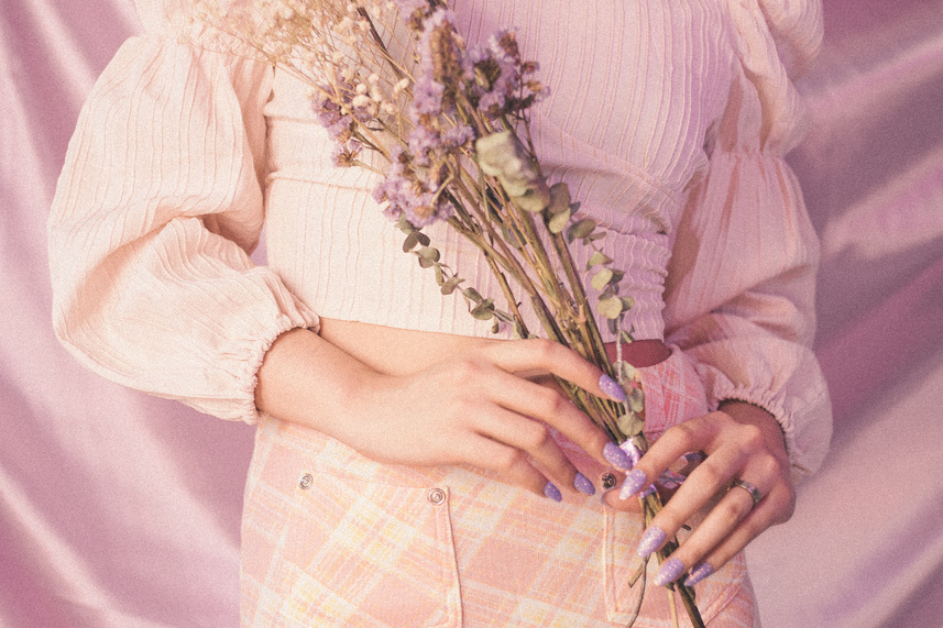 Woman in Vintage Outfit Holding a Bouqet of  Flowers